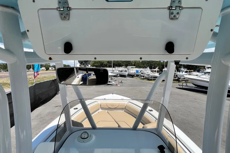 Slide: The Image of 2016 Sea Hunt Ultra 211 boat interior with console and seating, docked at a marina. - 44