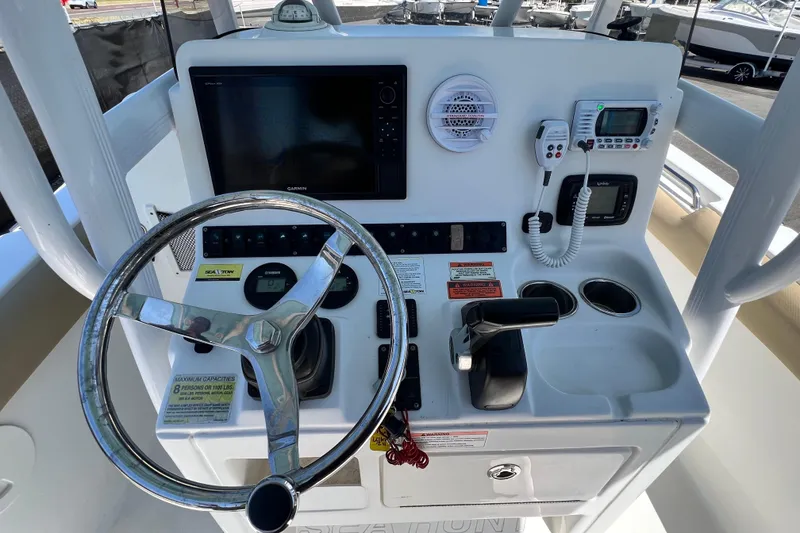 Slide: The Image of 2016 Sea Hunt Ultra 211 boat dashboard with steering wheel and navigation controls. - 49
