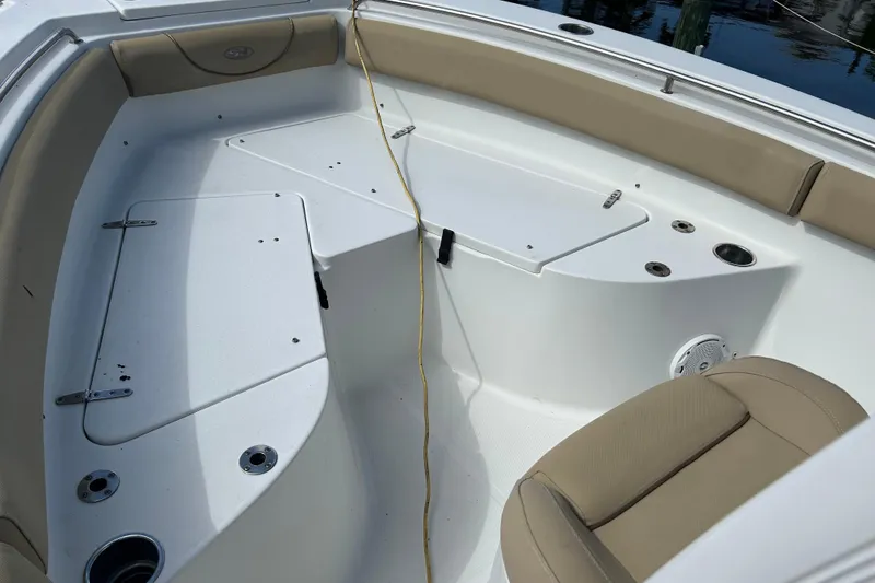 Slide: The Image of 2016 Sea Hunt Ultra 211 boat rear view with motor and trailer in a marina. - 5