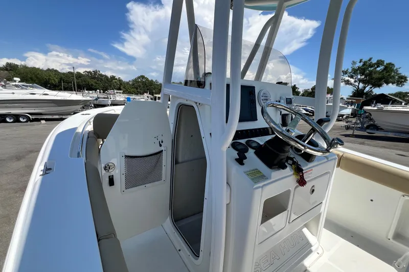 Slide: The Image of 2016 Sea Hunt Ultra 211 boat interior with steering console and seating area. - 50