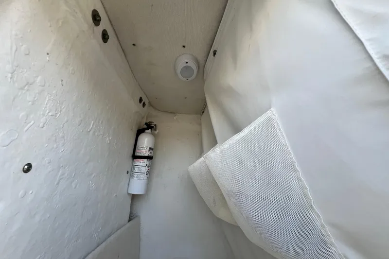 Slide: The Image of Interior of 2016 Sea Hunt Ultra 211 boat with fire extinguisher and storage pocket. - 52