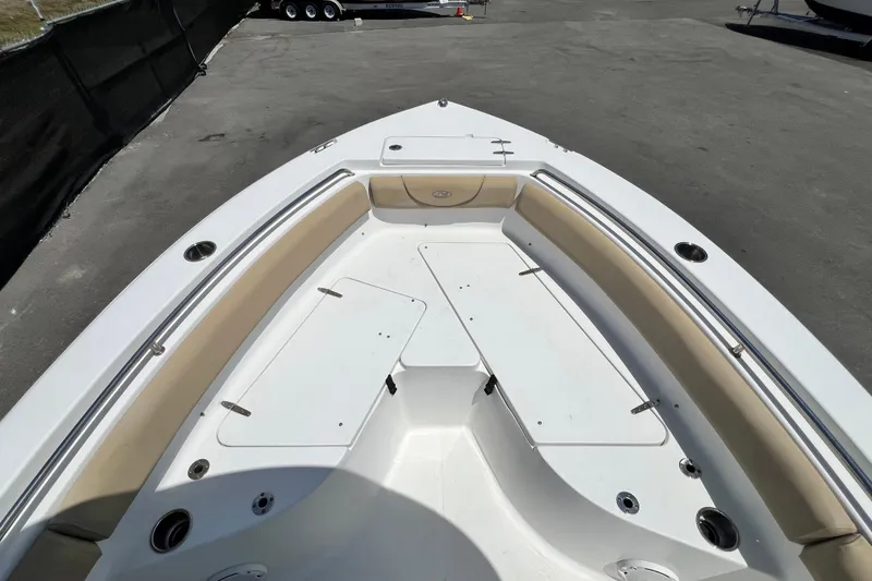 Slide: The Image of Bow seating area of a 2016 Sea Hunt Ultra 211 boat, featuring cushioned seats and storage compartments. - 54