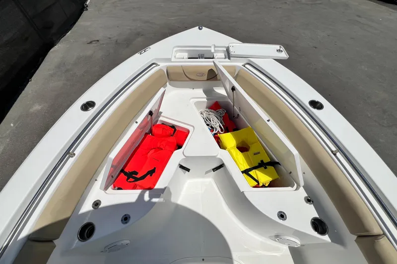 Slide: The Image of 2016 Sea Hunt Ultra 211 boat interior with storage compartments and safety gear. - 55