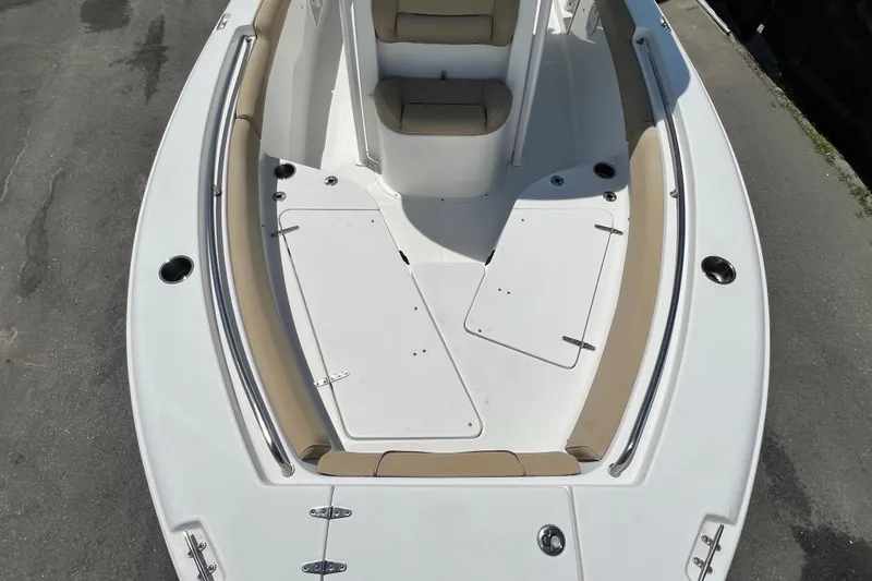 Slide: The Image of 2016 Sea Hunt Ultra 211 boat interior with cushioned seating and storage compartments. - 57