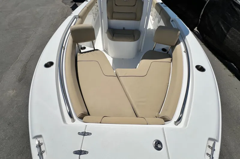 Slide: The Image of 2016 Sea Hunt Ultra 211 boat with beige cushioned seating and sleek white deck. - 58