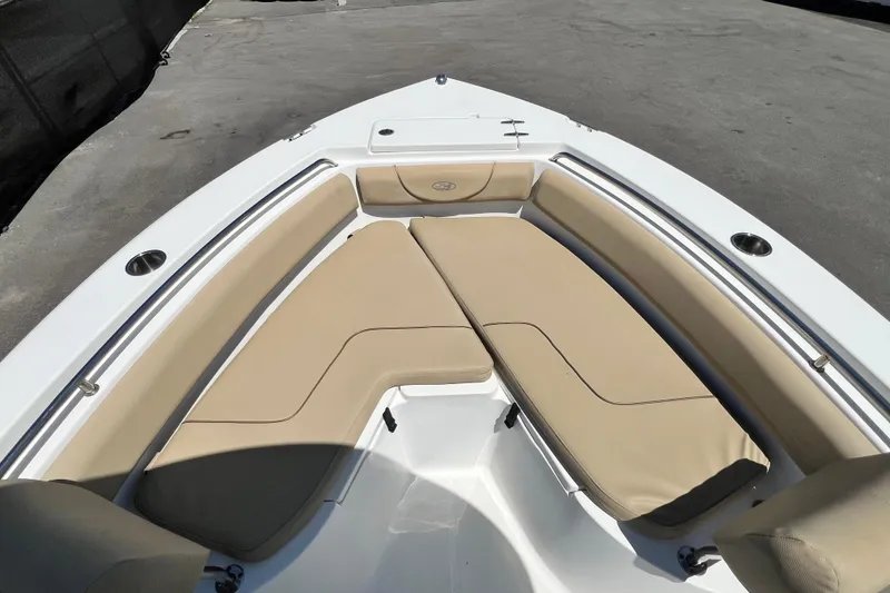 Slide: The Image of Bow seating area of a 2016 Sea Hunt Ultra 211 boat with beige cushions. - 61