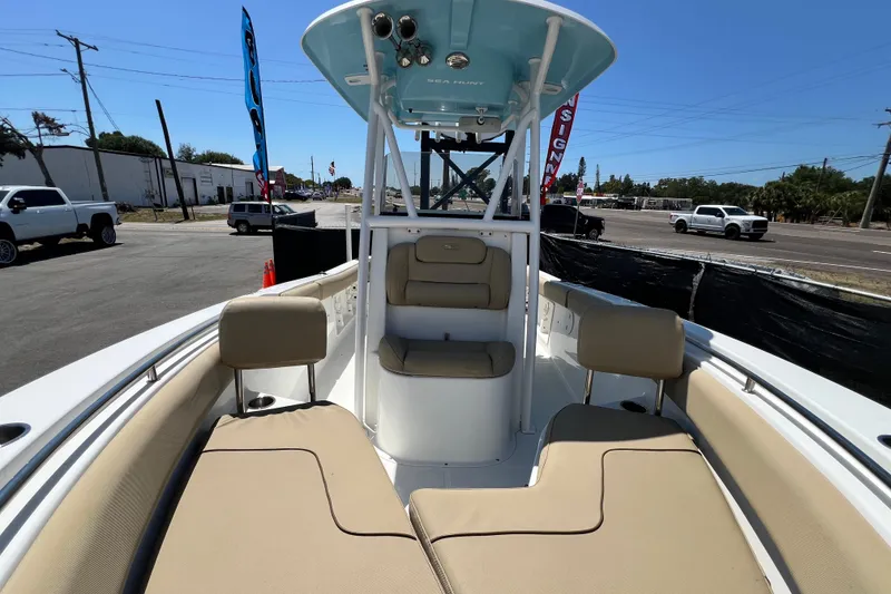 Slide: The Image of 2016 Sea Hunt Ultra 211 boat interior with beige seating and center console. - 64