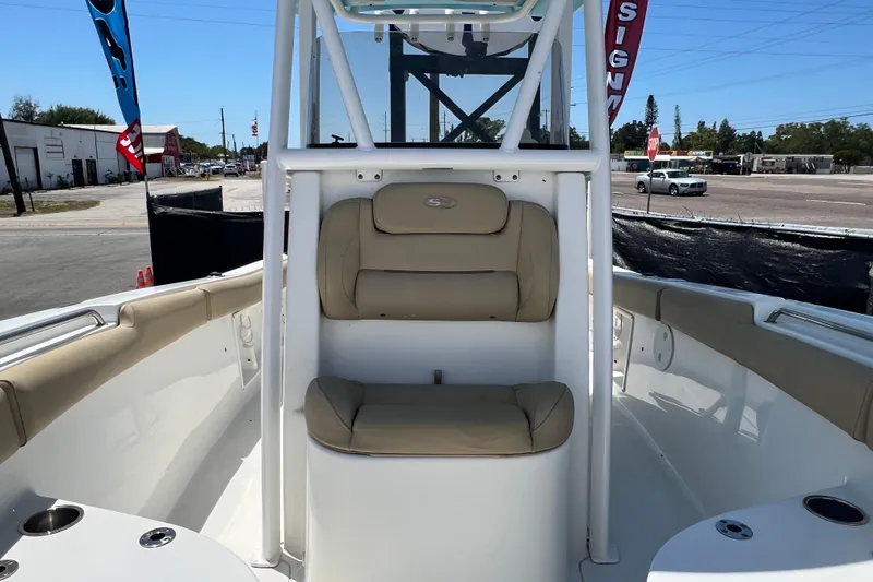 Slide: The Image of 2016 Sea Hunt Ultra 211 boat interior with beige seating and white console. - 67