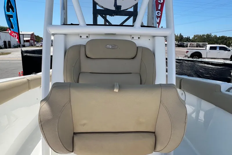 Slide: The Image of 2016 Sea Hunt Ultra 211 boat seat with beige upholstery, outdoor setting. - 68