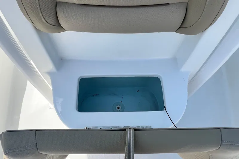 Slide: The Image of 2016 Sea Hunt Ultra 211 boat interior with storage compartment and cushioned seating. - 70