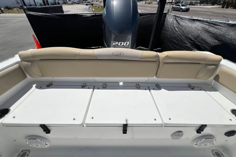 Slide: The Image of 2016 Sea Hunt Ultra 211 boat interior with cushioned seating and Yamaha 200 engine. - 71