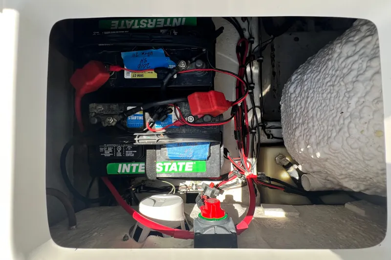 Slide: The Image of Battery compartment of a 2016 Sea Hunt Ultra 211 boat with Interstate batteries. - 74