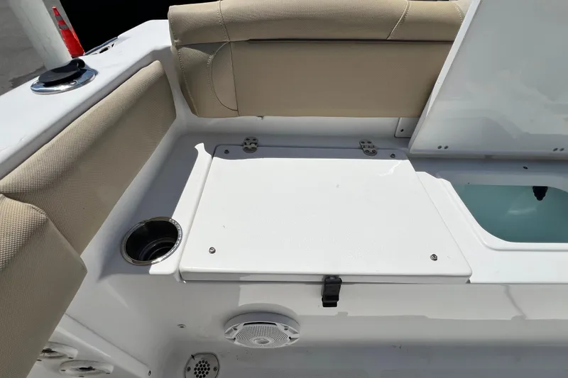 Slide: The Image of 2016 Sea Hunt Ultra 211 boat interior with cushioned seating and storage compartment. - 75