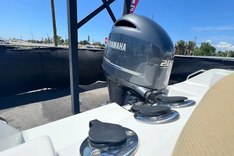 Slide: The Image of 2016 Sea Hunt Ultra 211 boat with Yamaha 200 outboard motor in a sunny setting. - 77
