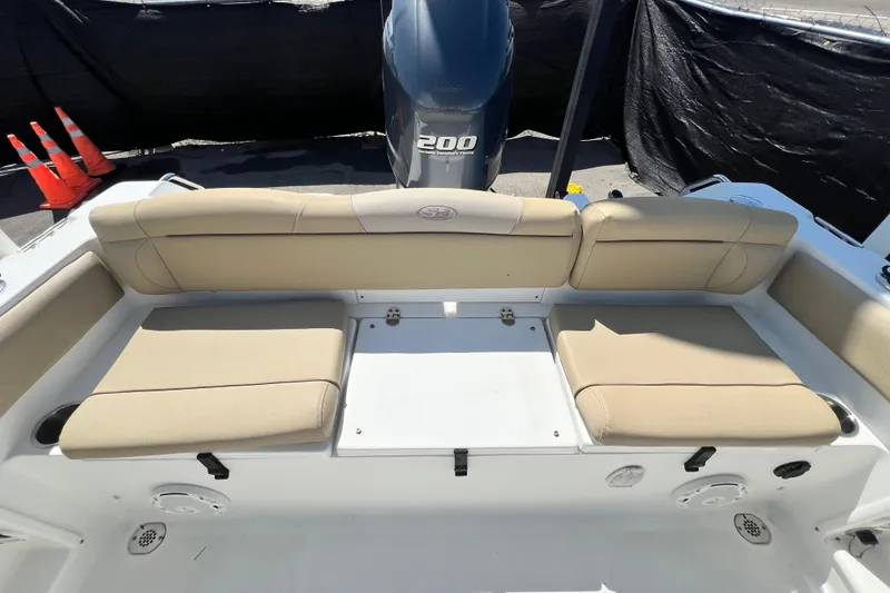 Slide: The Image of 2016 Sea Hunt Ultra 211 boat interior with beige seating and Yamaha 200 engine. - 87