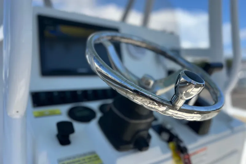 Slide: The Image of Steering wheel of a 2016 Sea Hunt Ultra 211 boat, close-up view. - 90