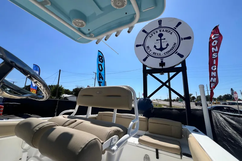 Slide: The Image of 2016 Sea Hunt Ultra 211 boat interior at a Tampa dealership with signage. - 91