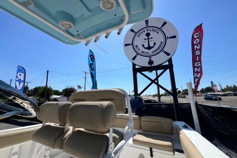 Slide: The Image of 2016 Sea Hunt Ultra 211 boat at dealership with consignment signs. - 92