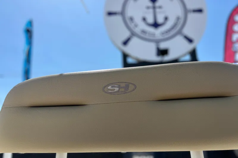 Slide: The Image of Beige seat of 2016 Sea Hunt Ultra 211 boat with logo, nautical background. - 93
