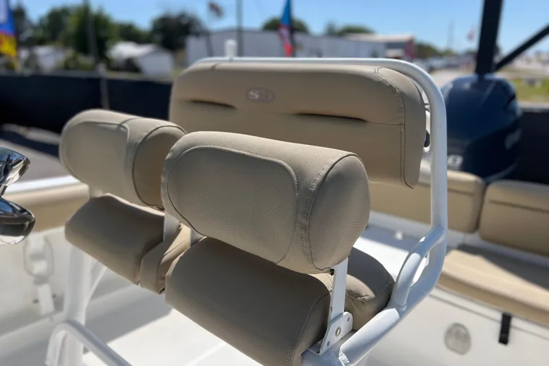 Slide: The Image of 2016 Sea Hunt Ultra 211 boat with beige cushioned seating and white frame. - 94