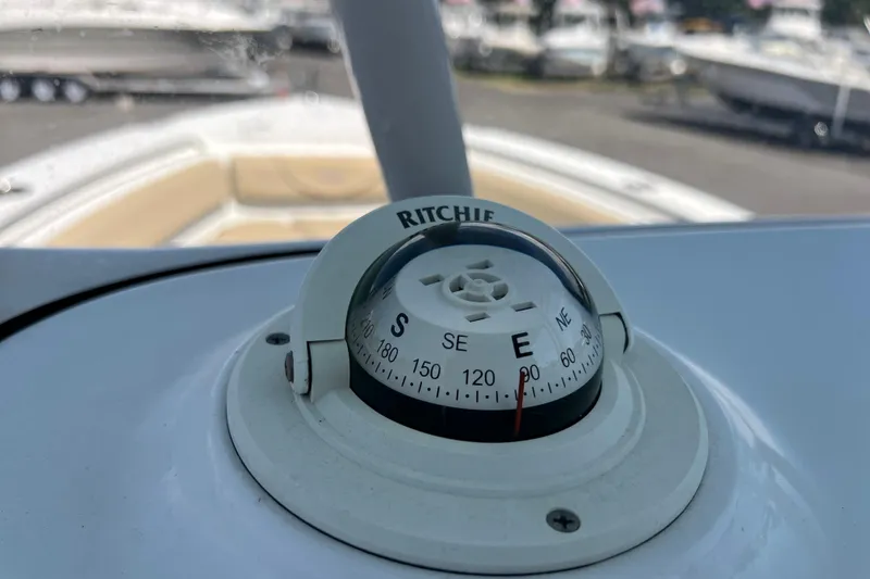 Slide: The Image of Compass on 2016 Sea Hunt Ultra 211 boat dashboard, showing east direction. - 95