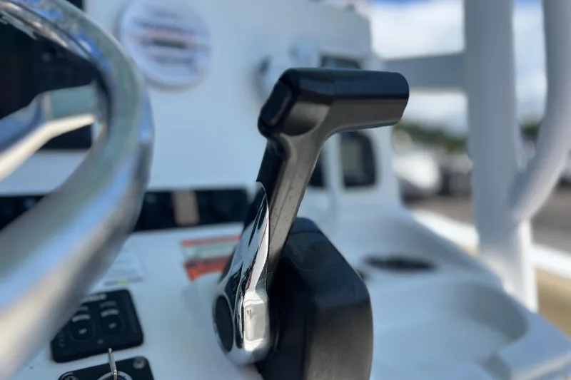 Slide: The Image of Close-up of 2016 Sea Hunt Ultra 211 boat throttle and steering wheel. - 96