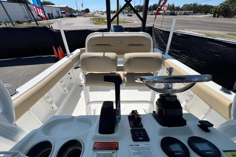Slide: The Image of 2016 Sea Hunt Ultra 211 boat interior with steering wheel and controls. - 97