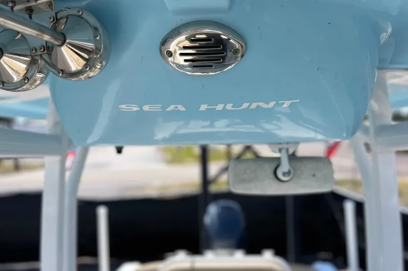 Slide: The Image of 2016 Sea Hunt Ultra 211 boat interior with blue console and speaker detail. - 98