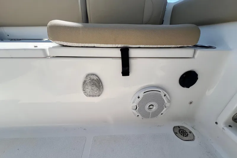 Slide: The Image of 2016 Sea Hunt Ultra 211 boat interior with speaker and beige seating. - 99