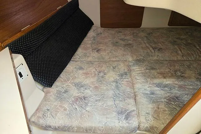 Slide: The Image of Interior cabin of a 2005 Catalina 310 sailboat with cushioned sleeping area. - 12