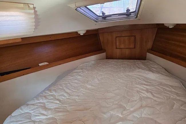 Slide: The Image of Cozy cabin interior of 2005 Catalina 310 sailboat with a comfortable bed. - 13
