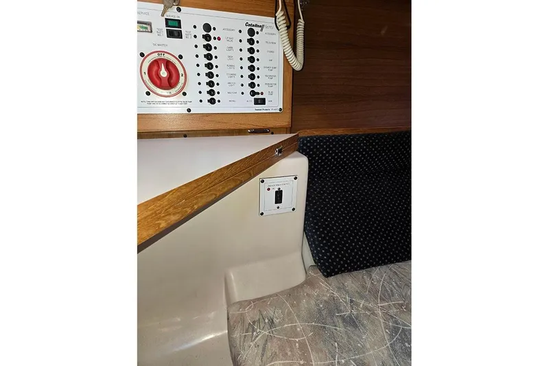 Slide: The Image of Control panel inside a 2005 Catalina 310 sailboat cabin with seating area. - 15