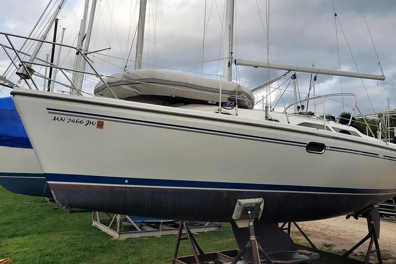 Slide: The Image of Catalina 310 sailboat from 2005 on a stand, with overcast sky background. - 3