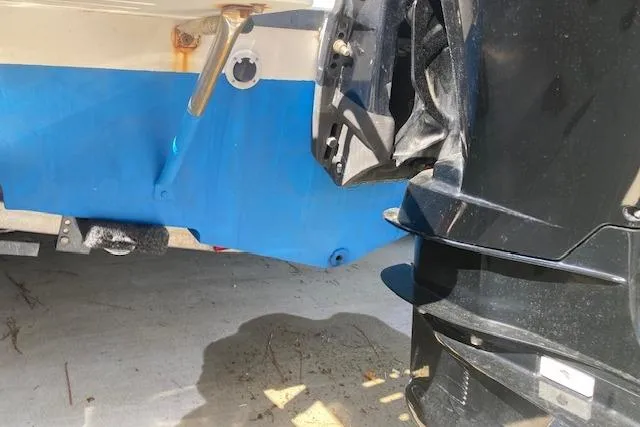 Slide: The Image of 2004 Palm Beach 205 cc boat on trailer in driveway, surrounded by greenery and trees. - 3