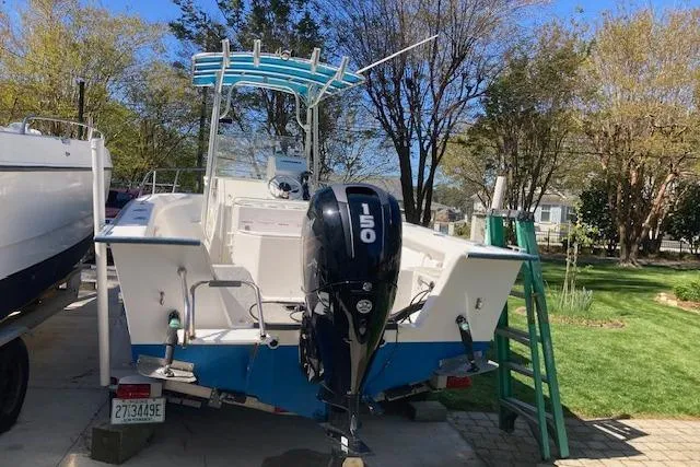 Slide: The Image of 2004 Palm Beach 205 cc boat with Mercury 150 engine, docked outdoors. - 4