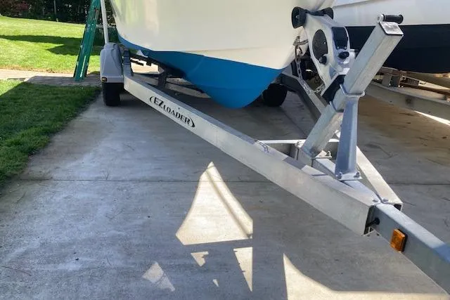 Slide: The Image of 2004 Palm Beach 205 cc boat with 150 HP engine, parked outdoors on a sunny day. - 6