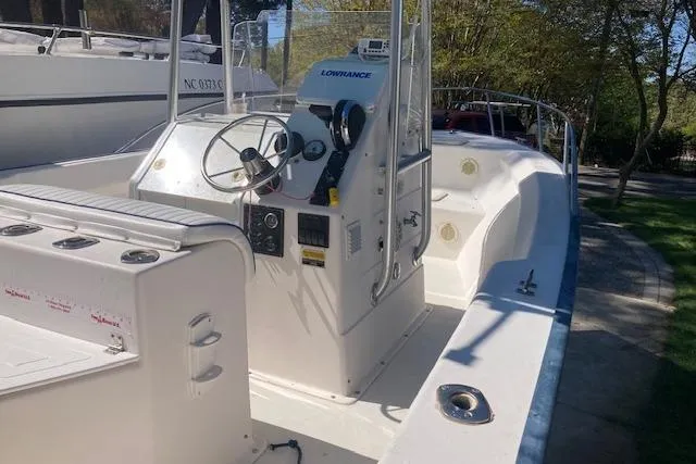 Slide: The Image of 2004 Palm Beach 205 cc boat with Mercury outboard motor in a sunny yard. - 7