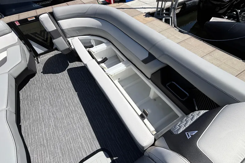 Slide: The Image of 2026 Viaggio D26U boat interior with open storage compartments and gray seating. - 13