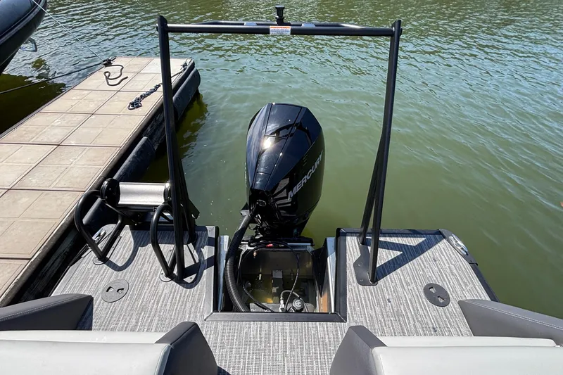 Slide: The Image of Rear view of a 2026 Viaggio D26U boat with Mercury outboard motor at dock. - 26