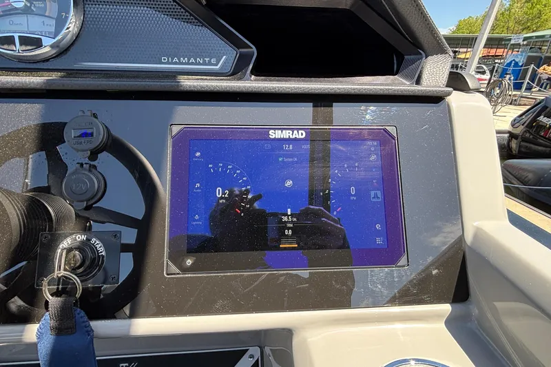 Slide: The Image of Dashboard of a 2026 Viaggio D26U boat featuring a Simrad display screen. - 34