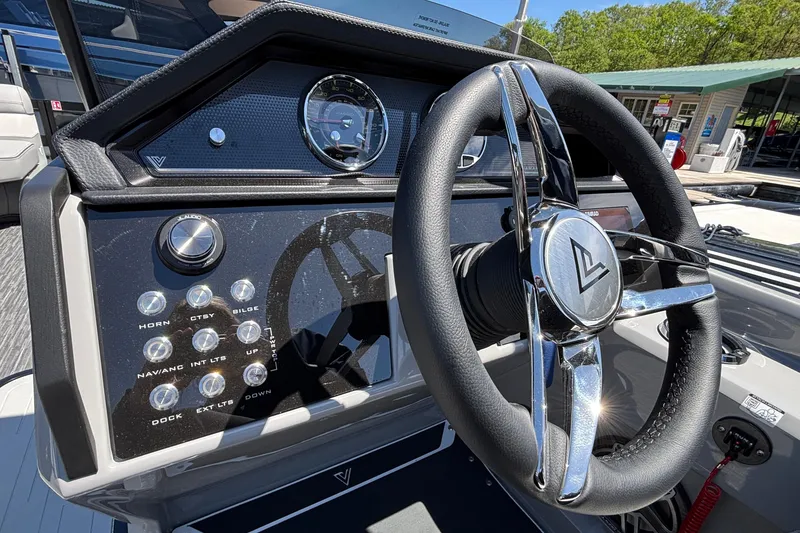 Slide: The Image of Steering wheel and dashboard of 2026 Viaggio D26U boat, featuring modern controls and sleek design. - 36
