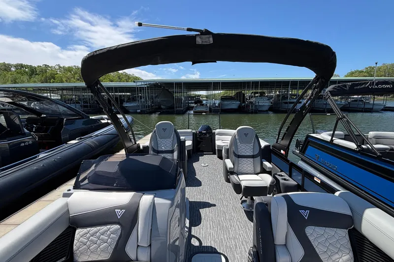 Slide: The Image of 2026 Viaggio D26U boat interior with luxurious seating, docked at a marina under a clear sky. - 7