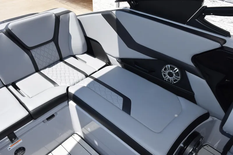 Slide: The Image of 2026 Yamaha Boats 255XD interior with sleek gray seating and modern speaker design. - 11