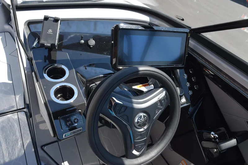 Slide: The Image of 2026 Yamaha Boats 255XD dashboard with steering wheel, touchscreen, and cup holders. - 15