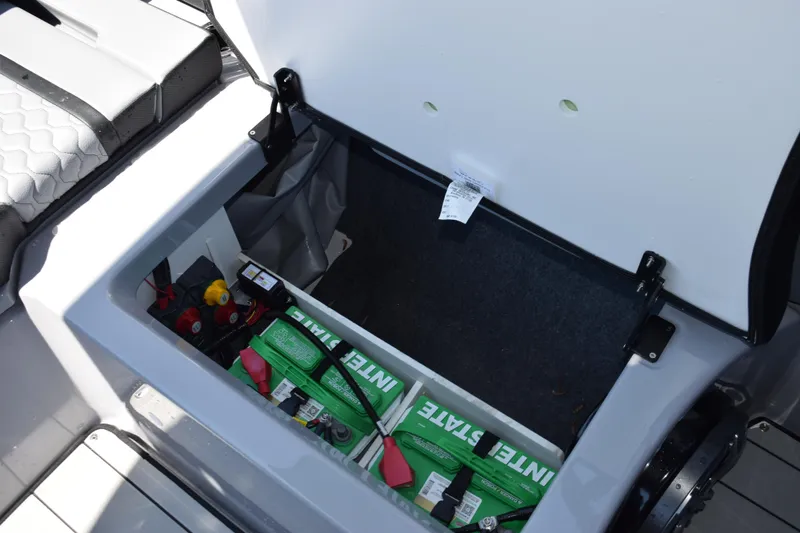 Slide: The Image of Open battery compartment of 2026 Yamaha Boats 255XD, showcasing Interstate batteries. - 24