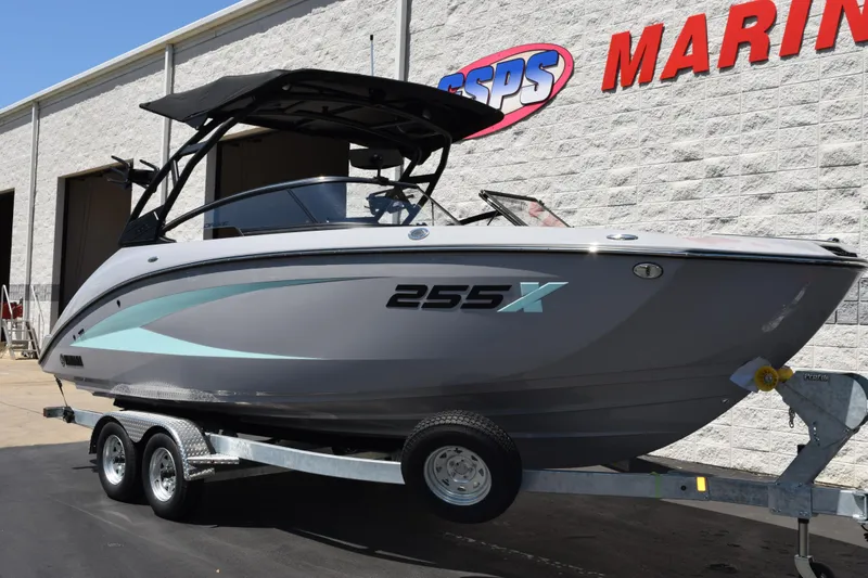 Slide: The Image of 2026 Yamaha Boats 255XD on trailer outside marine dealership. - 26