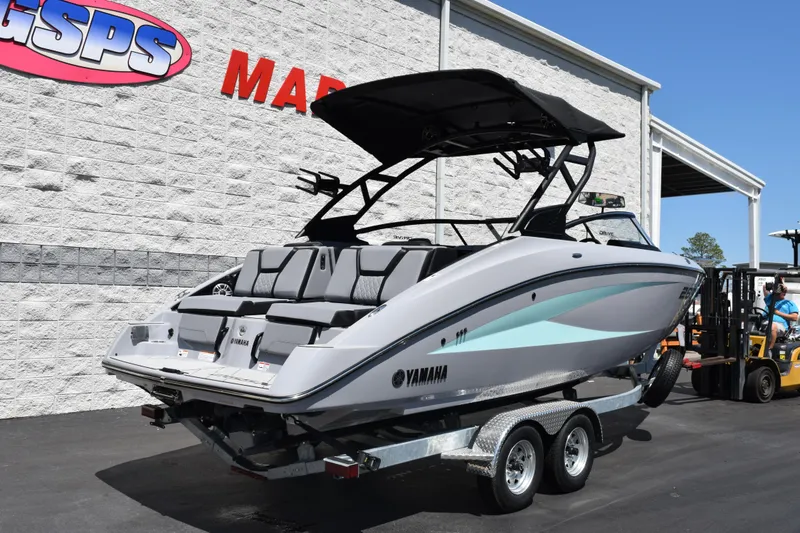 Slide: The Image of 2026 Yamaha Boats 255XD on trailer outside dealership, showcasing sleek design and modern features. - 28