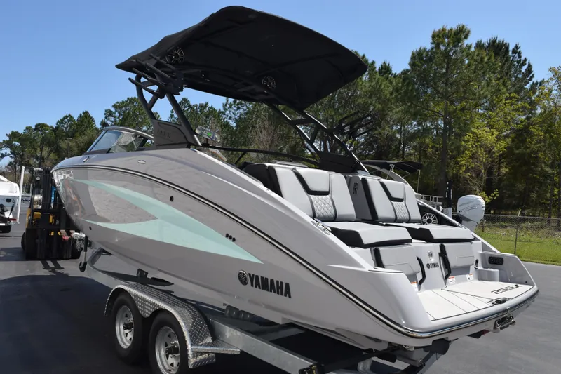 Slide: The Image of 2026 Yamaha Boats 255XD on trailer, sleek design, parked outdoors. - 6