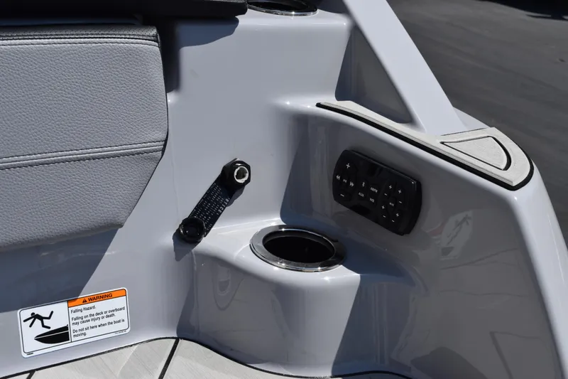 Slide: The Image of 2026 Yamaha Boats 255XD interior detail with control panel and cup holder. - 7