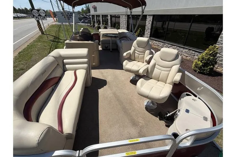 Slide: The Image of 2012 Sweetwater Premium Edition 220 DL pontoon boat with beige seating and spacious deck. - 11